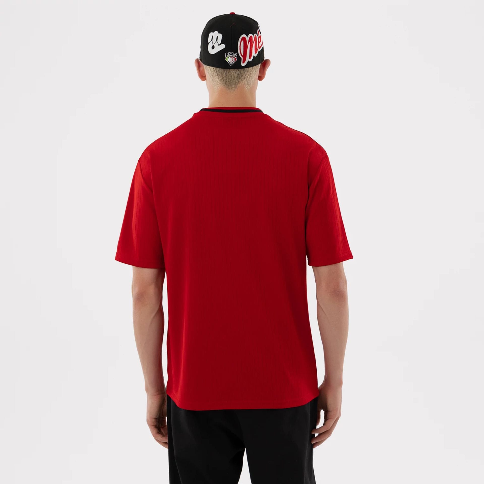 The model is wearing this LMB Mexico Diablos T-Shirt in red. 2