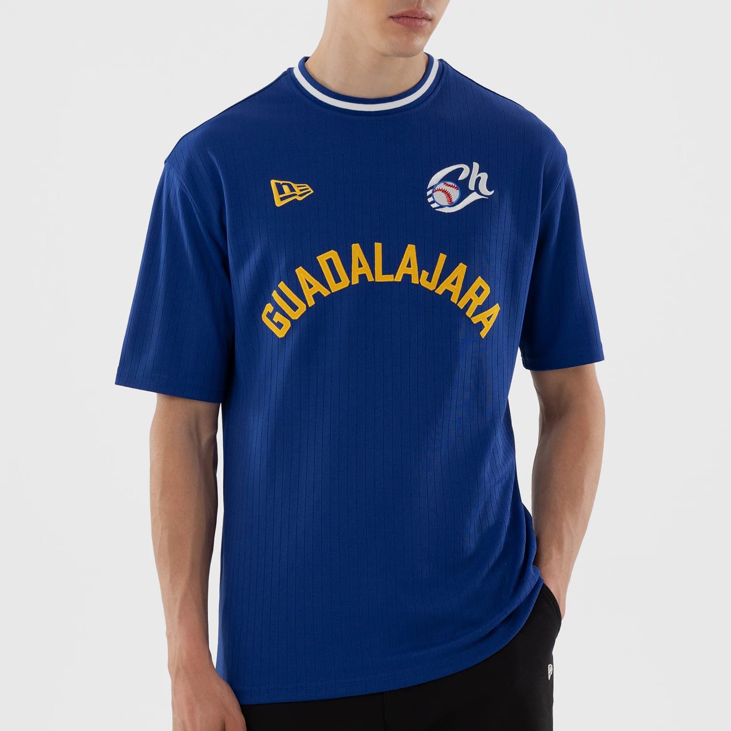 The model is wearing this LMB Charros De Jalisco Oversized T-Shirt in blue. 4