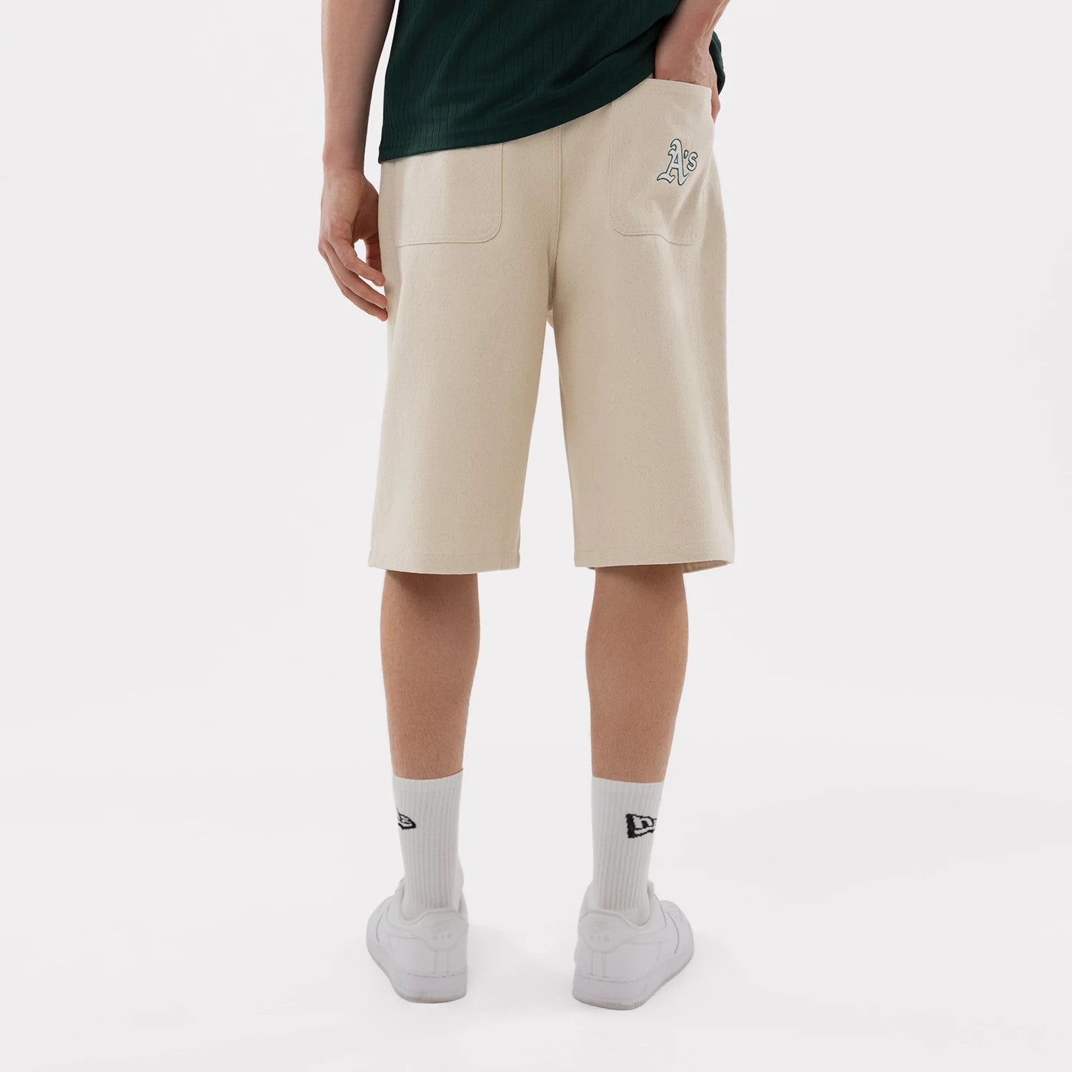 The model is wearing this MLB Jort Athletics Oversized Shorts in Cream. 2