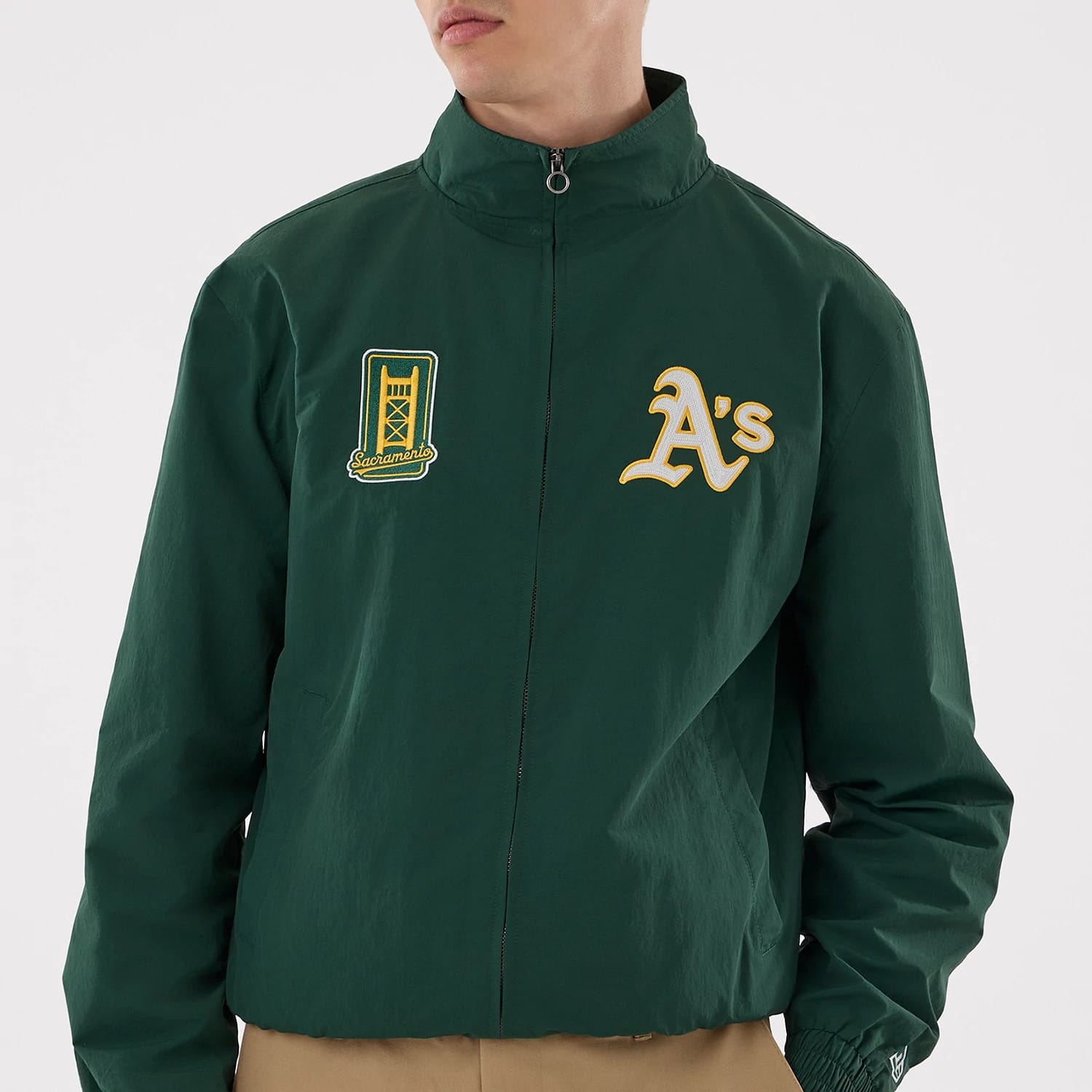 The model is wearing this MLB Athletics Sports Jacket in dark green. 3