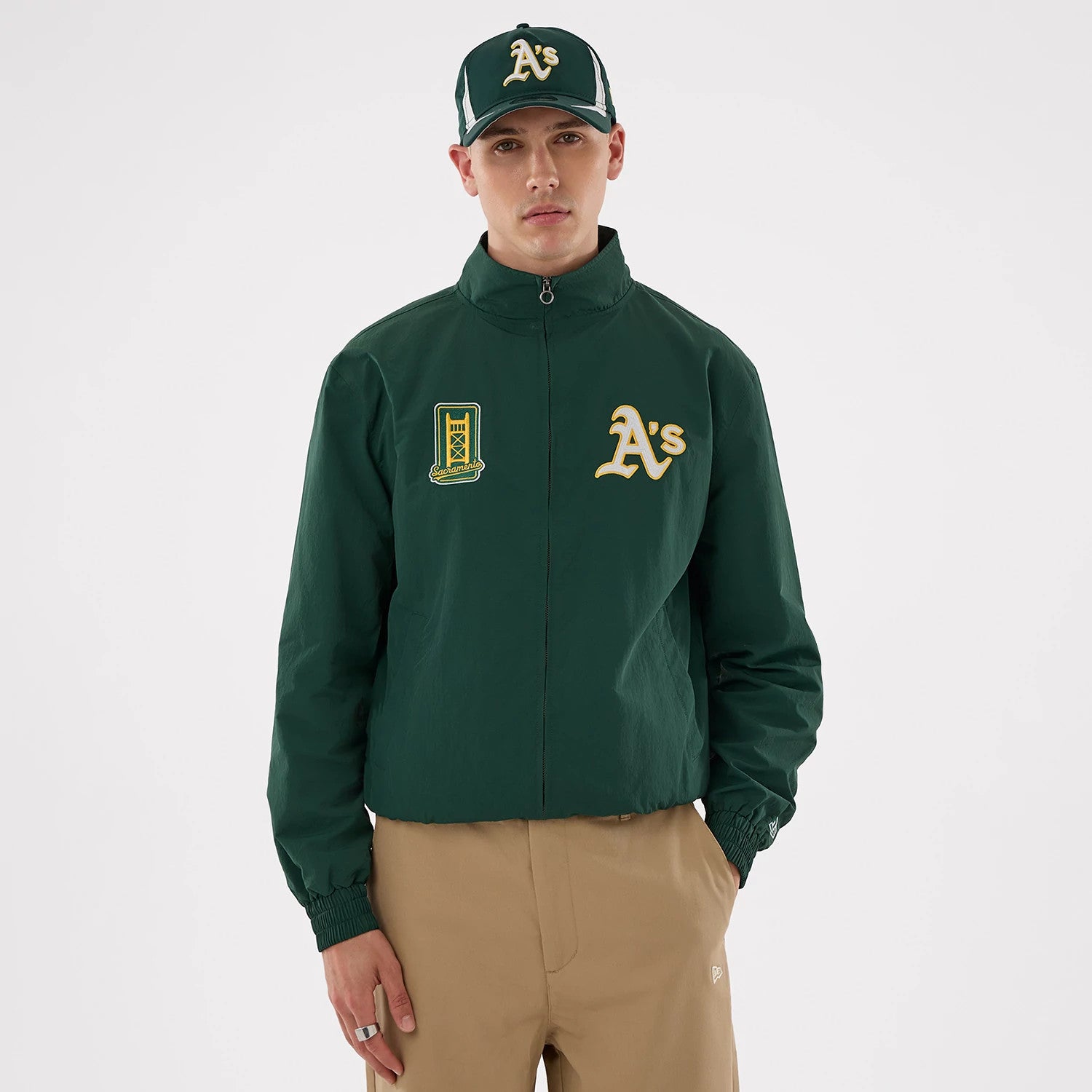 The model is wearing this MLB Athletics Sports Jacket in dark green. 1