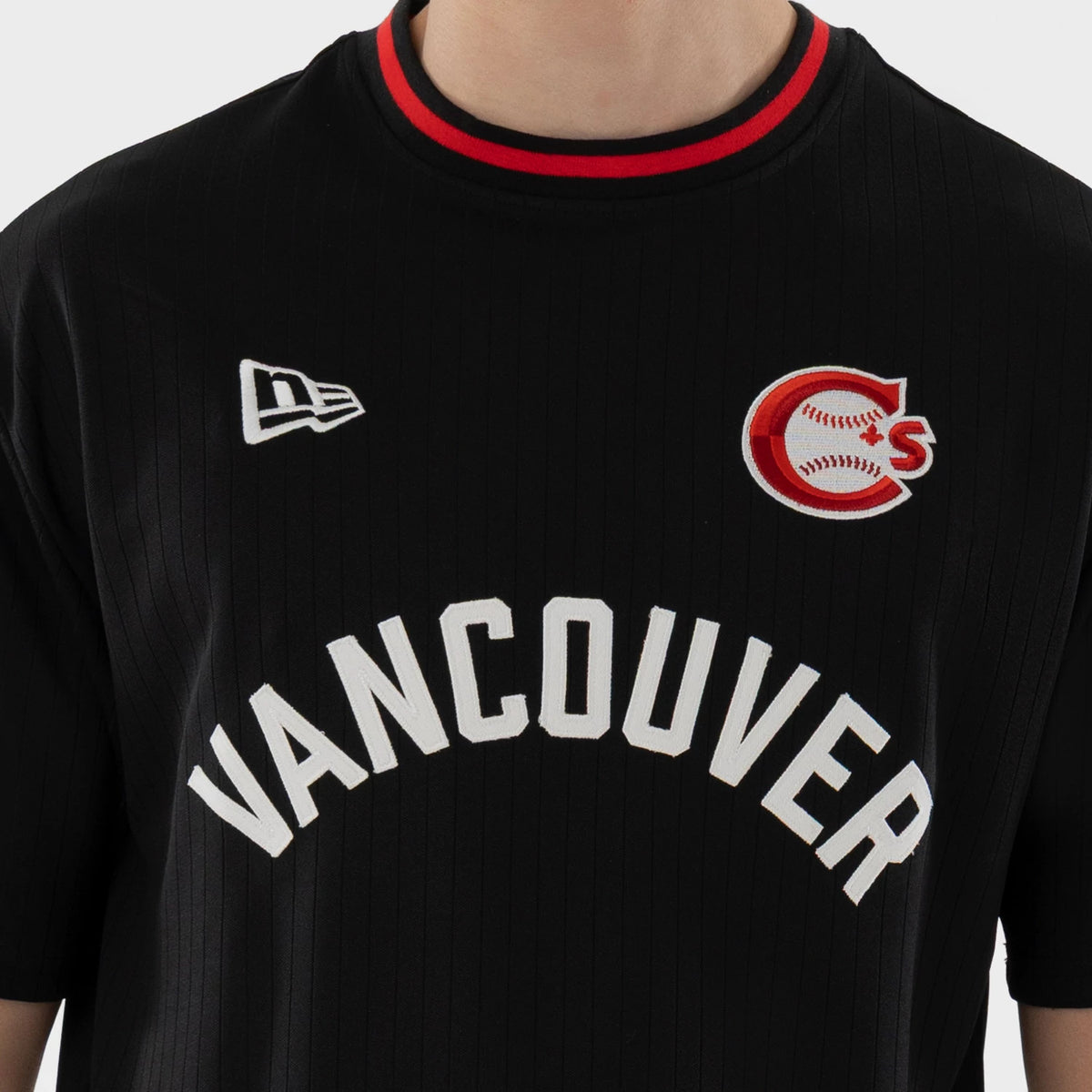 New Era Vancouver Canadians MiLB Black Oversized T-Shirt, front view showing the white embroidered Vancouver lettering across the chest, the embroidered team logo on the upper left, and a small New Era logo on the right side.