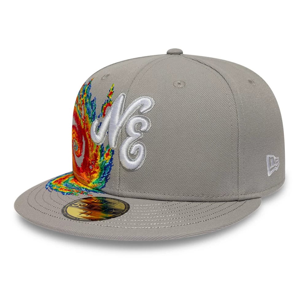 New Era Storm Pattern Grey 59FIFTY Fitted Cap, three-quarter view showing a white embroidered NE logo on the front panel against a vivid multicoloured storm pattern, with a structured grey crown and a gold 59FIFTY size sticker on the flat visor.