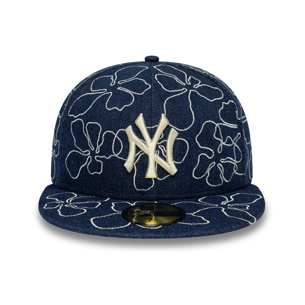 New York Yankees MLB Floral Denim Blue New Era 59FIFTY Fitted Cap, front view showing a raised embroidered cream NY logo on the structured denim crown, floral white embroidery across the panels and visor.