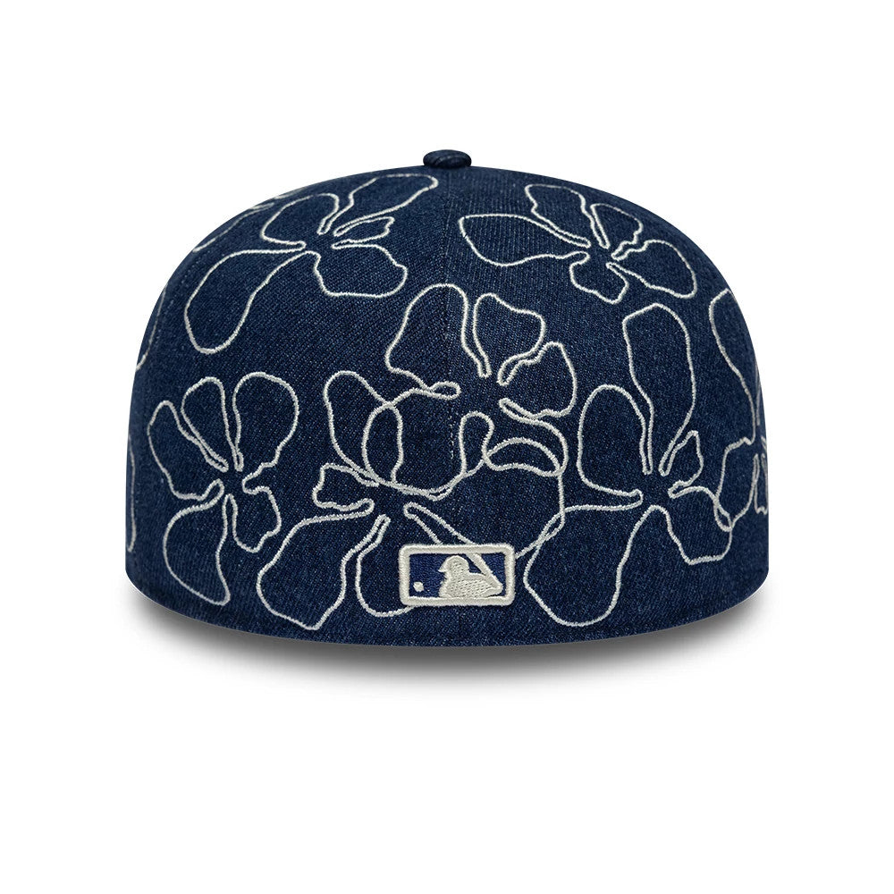 New York Yankees MLB Floral Denim Blue New Era 59FIFTY Fitted Cap, rear view showing the white embroidered MLB Batterman logo at the centre back of the structured denim crown, featuring an intricate white floral pattern.