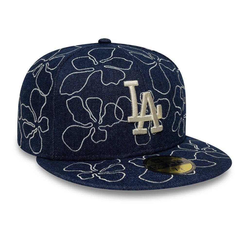 LA Dodgers MLB Floral Denim Blue New Era 59FIFTY Fitted Cap, front view showing an ivory embroidered LA logo on the front panel, outlined floral pattern across the denim surface, and a gold 59FIFTY size sticker on the flat visor.