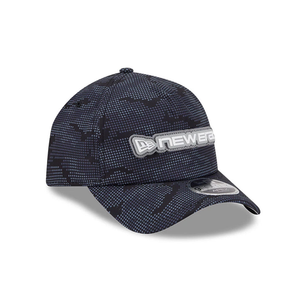 New Era Golf Black Camo 9FORTY Apex Adjustable Cap, three-quarter view showing a raised silver embroidered New Era logo on the front panel, black camo pattern throughout, and a 9FORTY size sticker on the dark visor.