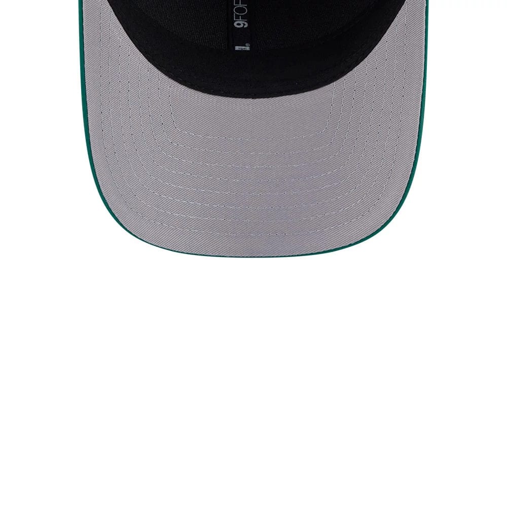 New Era Golf Green 9FORTY M-Crown Adjustable Cap, inside view showing the grey undervisor with stitching, the black sweatband featuring a 9FORTY size sticker, and hints of the green edge detail along the visor.