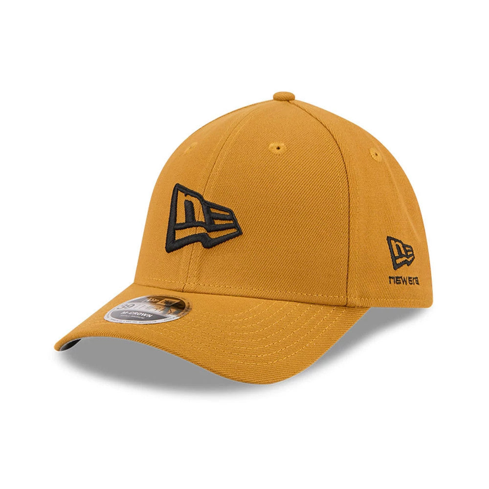 New Era Flag Gold New Era 39THIRTY M-Crown Stretch Fit Cap, front three-quarter view with a black embroidered New Era flag logo on the front panel, black New Era script on the left side, and a 39THIRTY size sticker on the curved visor.