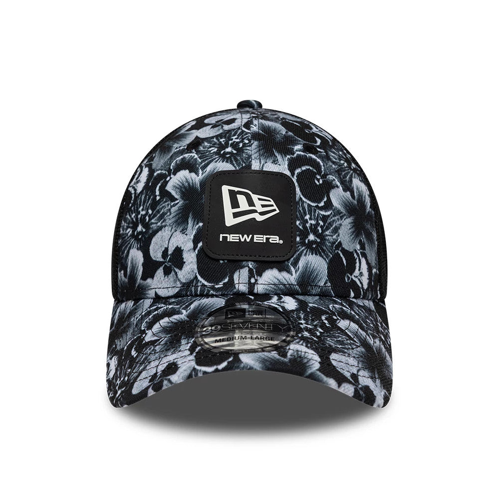 New Era Floral Black 39SEVENTY Stretch Fit Cap, front view showing a white embroidered New Era square patch logo on the structured, floral-patterned crown, with a curved visor and a 39SEVENTY size sticker on the visor.