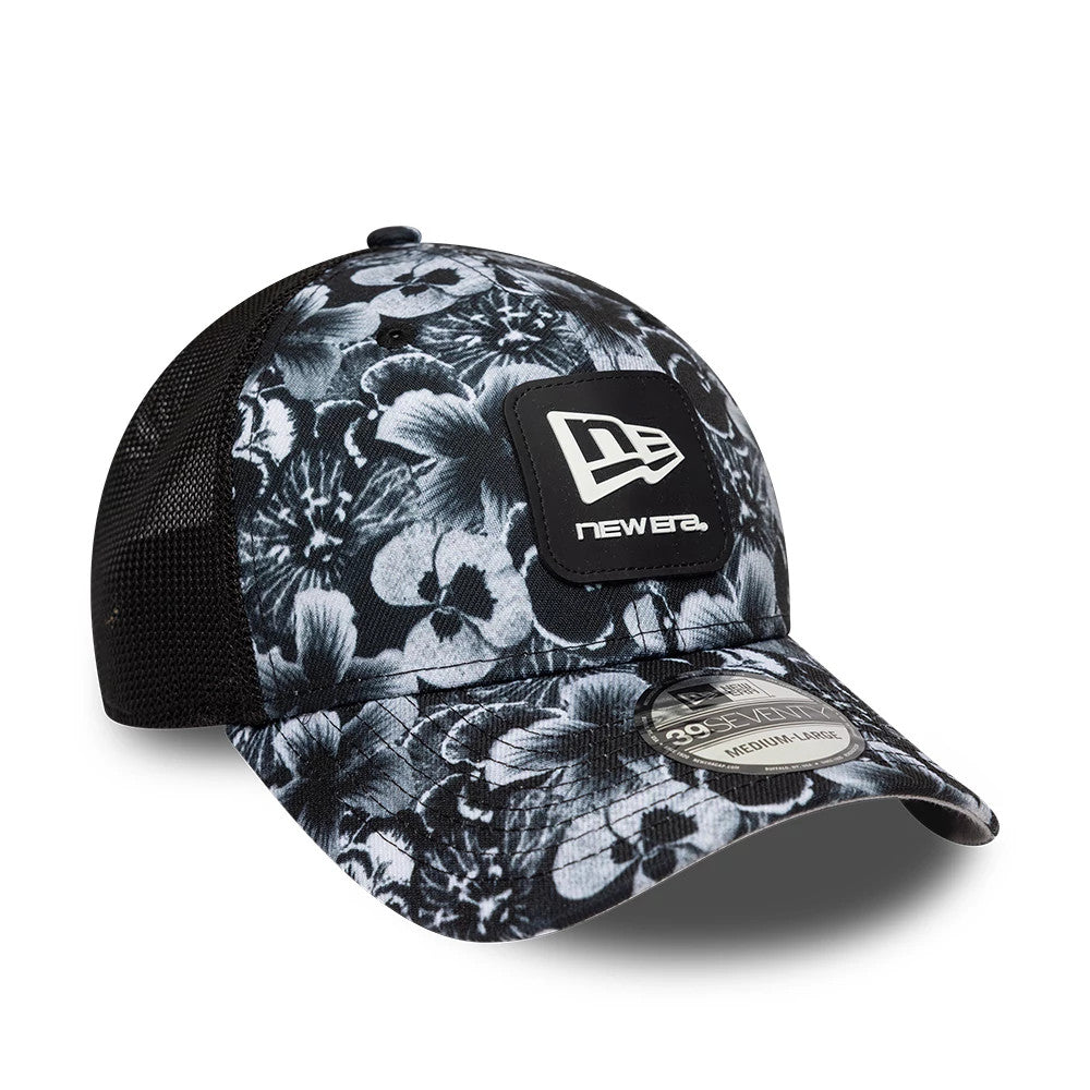 New Era Floral Black 39SEVENTY Stretch Fit Cap, three-quarter view showing the raised black and white New Era logo on the front panel, a floral pattern across the structured crown, and a 39SEVENTY size sticker on the curved visor.
