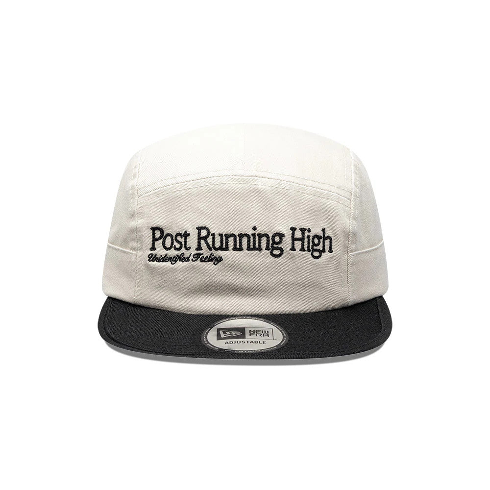 New Era X Hermanos Koumori Running Light Beige Camper Cap, front view showing the black embroidered Post Running High text on the light beige front panel, paired with a contrasting black visor and a centre New Era size sticker.