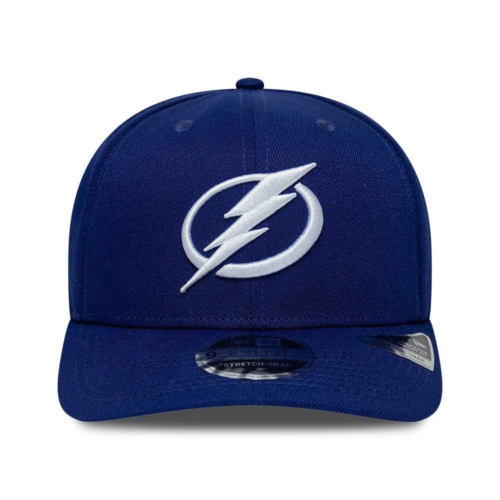 Tampa Bay Lightning NHL Team Blue New Era 9SEVENTY Stretch Snap Adjustable Cap, front view showing the prominent white embroidered team logo on the structured blue front panels, with a 9SEVENTY size sticker on the curved blue visor.