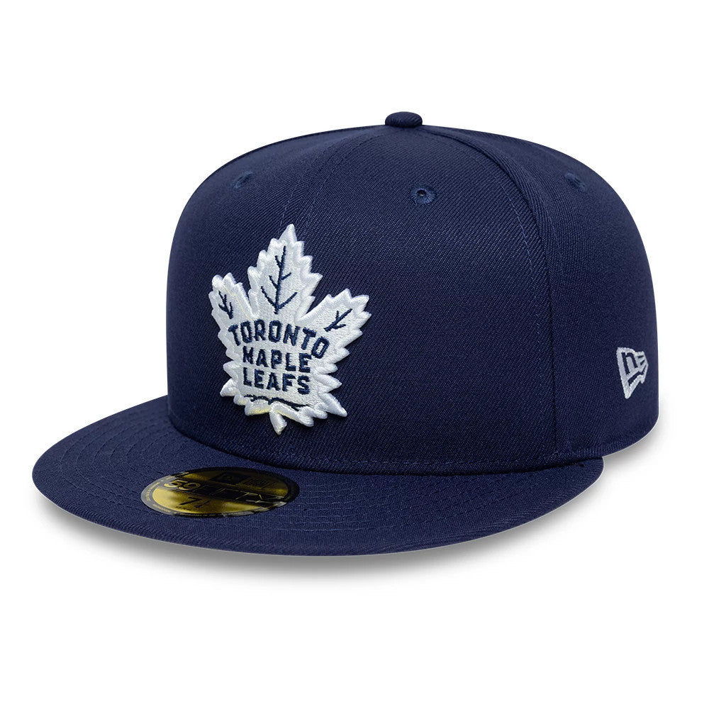 Toronto Maple Leafs NHL Basic Navy New Era 59FIFTY Fitted Cap, three-quarter view showing the white embroidered leaf logo with team lettering on the structured navy crown, a navy visor with a gold 59FIFTY size sticker.