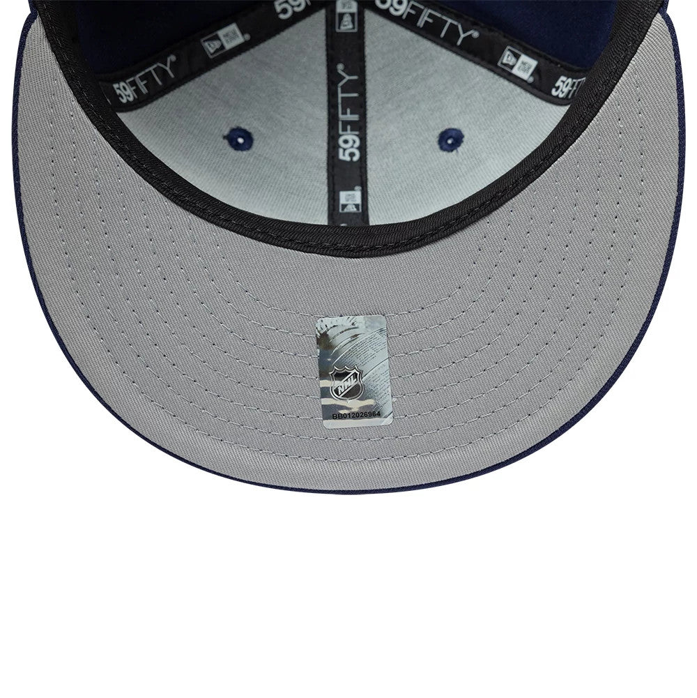Toronto Maple Leafs NHL Basic Navy New Era 59FIFTY Fitted Cap, inside view showing grey undervisor with an NHL sticker, black inner taping with 59FIFTY branding, and navy eyelets on a structured six-panel crown.