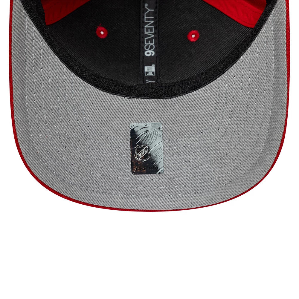 Florida Panthers NHL Team Red New Era 9SEVENTY Stretch Snap Adjustable Cap, inside view showing the black taping with 9SEVENTY branding, a grey undervisor, and a silver NHL sticker centrally placed near the edge.