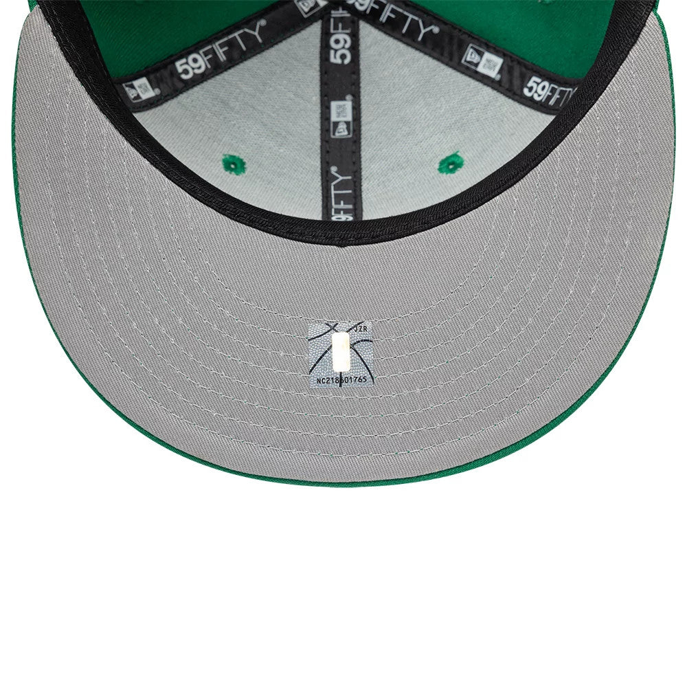 Boston Celtics NBA Basic Green New Era 59FIFTY Fitted Cap, inside view showing black 59FIFTY taping along the seams, a grey undervisor with a size sticker, and green eyelets set against a green interior crown.