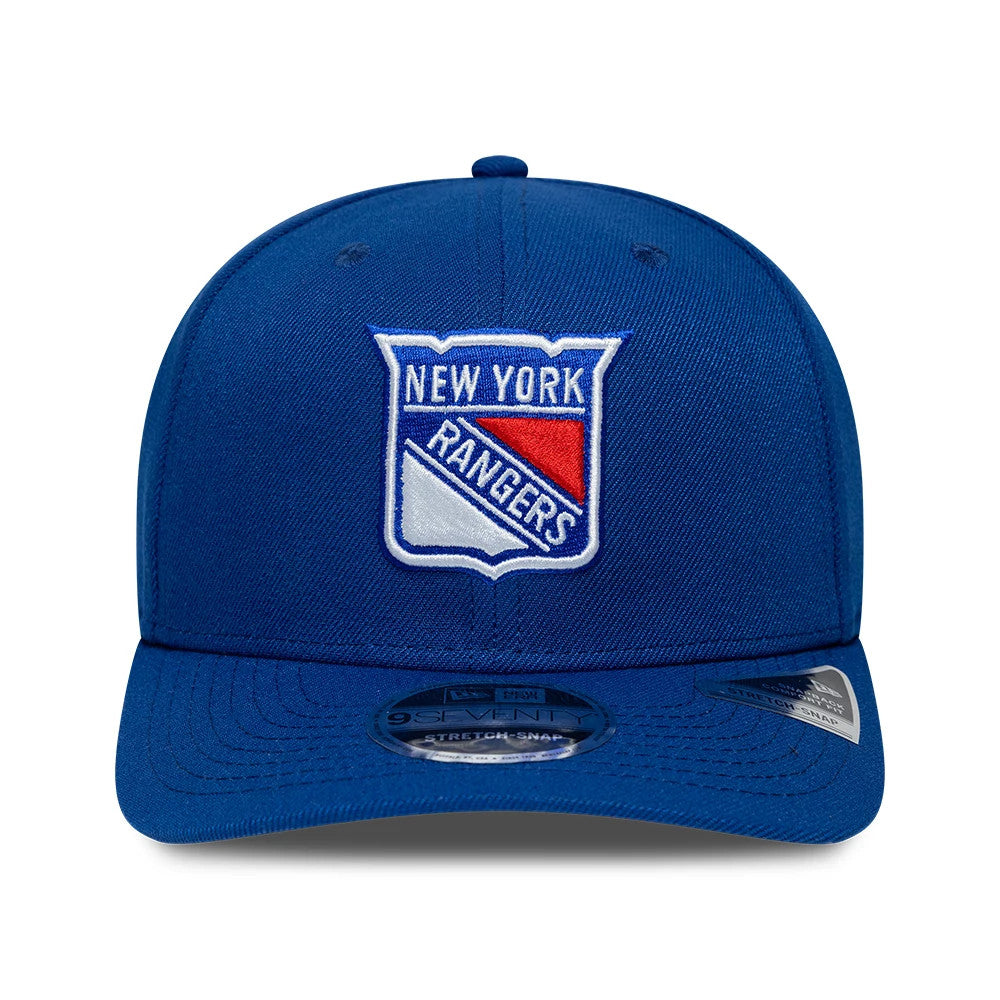 New York Rangers NHL Team Blue New Era 9SEVENTY Stretch Snap Adjustable Cap, front view showing the raised embroidered Rangers logo on the centre front panel, blue curved visor with a 9SEVENTY size sticker, and matching top button.