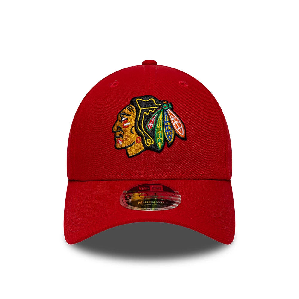 Chicago Blackhawks NHL Team Red New Era 9FORTY M-Crown Adjustable Cap, front view showing the intricately embroidered team logo in black, green, and yellow on the structured red crown, with a red curved visor and 9FORTY size sticker.