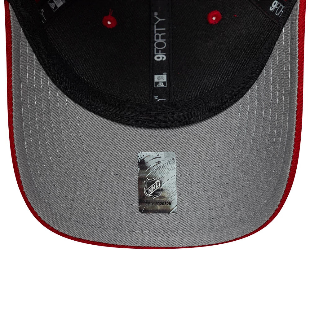 Chicago Blackhawks NHL Team Red New Era 9FORTY M-Crown Adjustable Cap, inside view showing the grey undervisor with an NHL sticker, black interior taping featuring New Era and 9FORTY branding, and black sweatband contrast.
