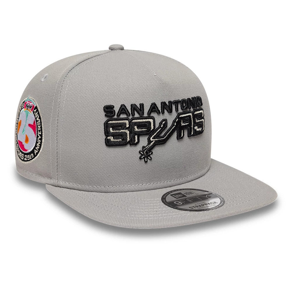 San Antonio Spurs NBA Hardwood Classic Grey New Era 9FIFTY A-Frame Snapback Adjustable Cap, three-quarter view showing the black embroidered San Antonio Spurs logo on the front panel, grey flat visor, and left panel 25th Anniversary patch.