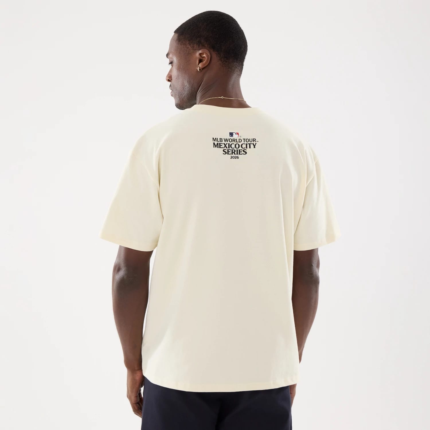 The model is wearing this MLB Mexico City Series 2026 Clash MLB Dueling Logo T-Shirt in Cream 2