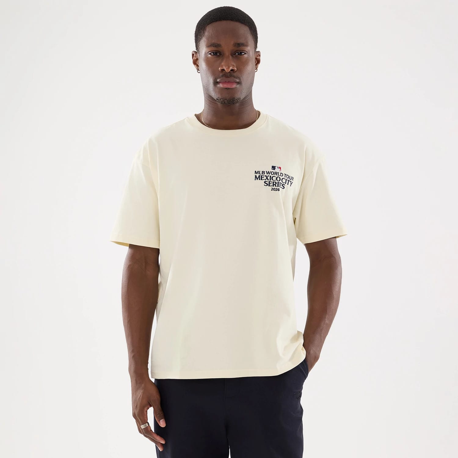 The model is wearing this MLB Mexico City Series 2026 Script Dueling Logo T-Shirt in Cream. 1
