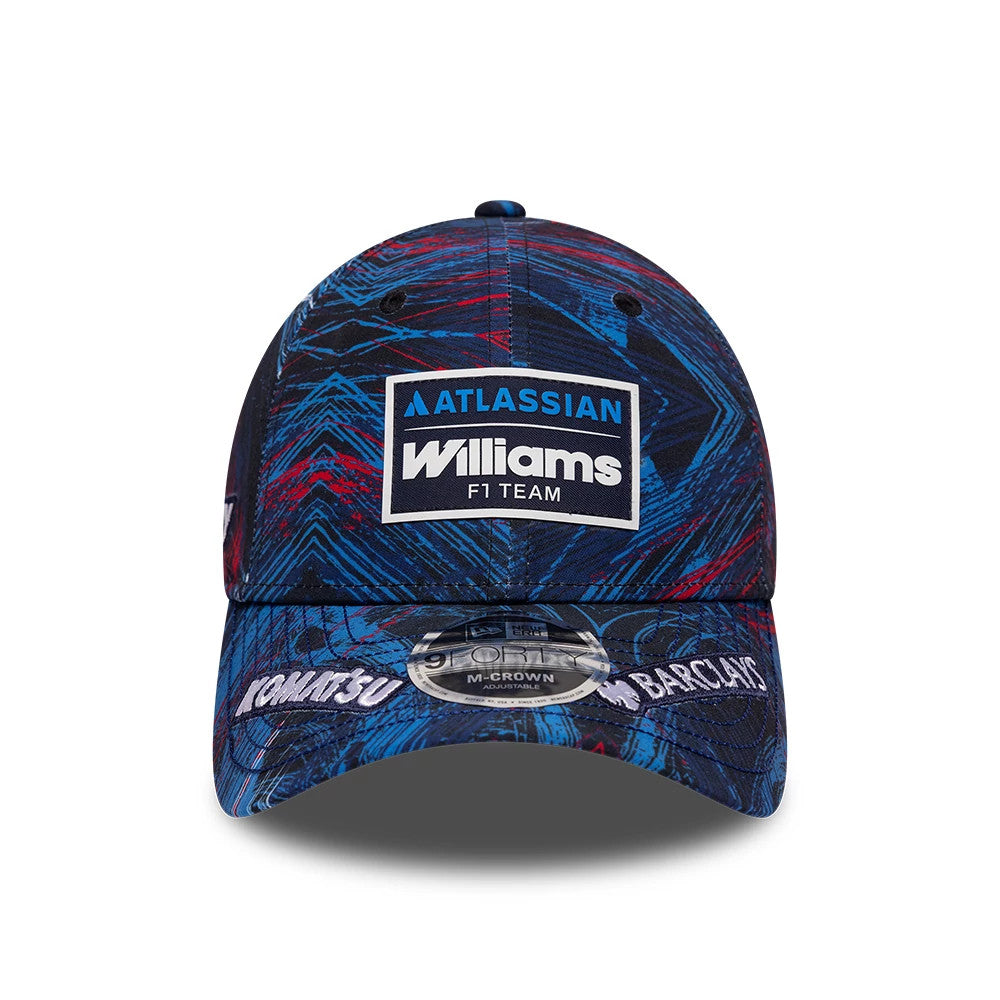 Williams GB Race Special Navy New Era 9FORTY M-Crown Adjustable Cap, front view showing the embroidered Williams F1 Team logo in white and blue on the front panel, with a dynamic navy pattern throughout and a 9FORTY size sticker on the navy visor.