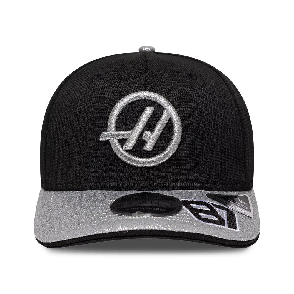 TGR Haas F1 Oliver Bearman Vegas Race Special Black New Era 9SEVENTY Stretch Snap Adjustable Cap, front view showing a silver embroidered logo on the black front panel, with a contrasting silver visor featuring a black 9SEVENTY size sticker.