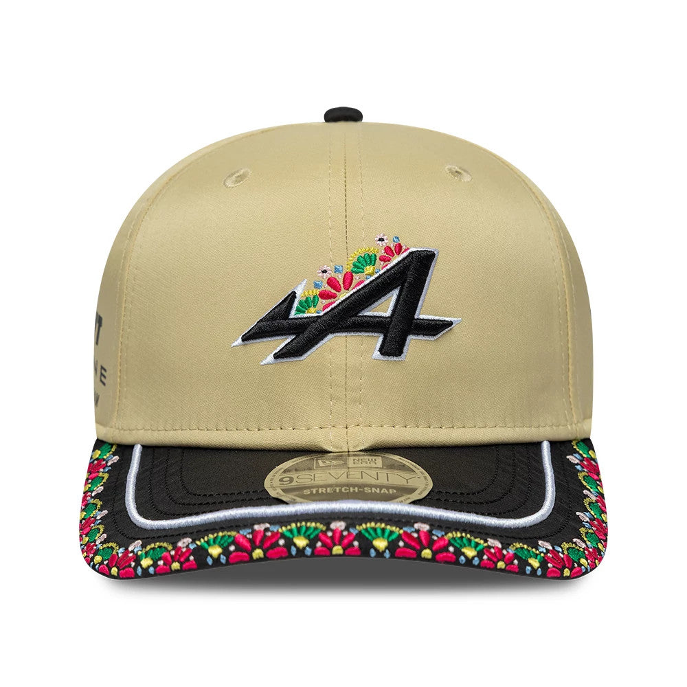 Alpine Racing Latin American Light Beige New Era 9SEVENTY Stretch Snap Adjustable Cap, front view showing a black embroidered A logo with colourful floral accents on the structured crown, black visor with floral embroidery.