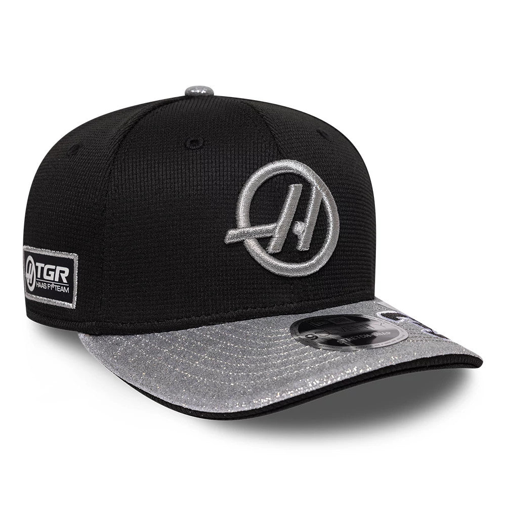 TGR Haas F1 Esteban Ocon Vegas Race Special Black New Era 9SEVENTY Stretch Snap Adjustable Cap, three-quarter view showing a silver embroidered logo on the front panel, a silver visor with a 9SEVENTY size sticker and a patch on the left side.