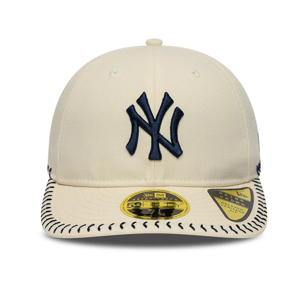 New York Yankees MLB Baseball Stitch Cream Retro Crown New Era 59FIFTY Fitted Cap, front view showing the navy embroidered NY logo on the structured cream crown, black baseball stitch pattern on the visor, and gold 59FIFTY size sticker.
