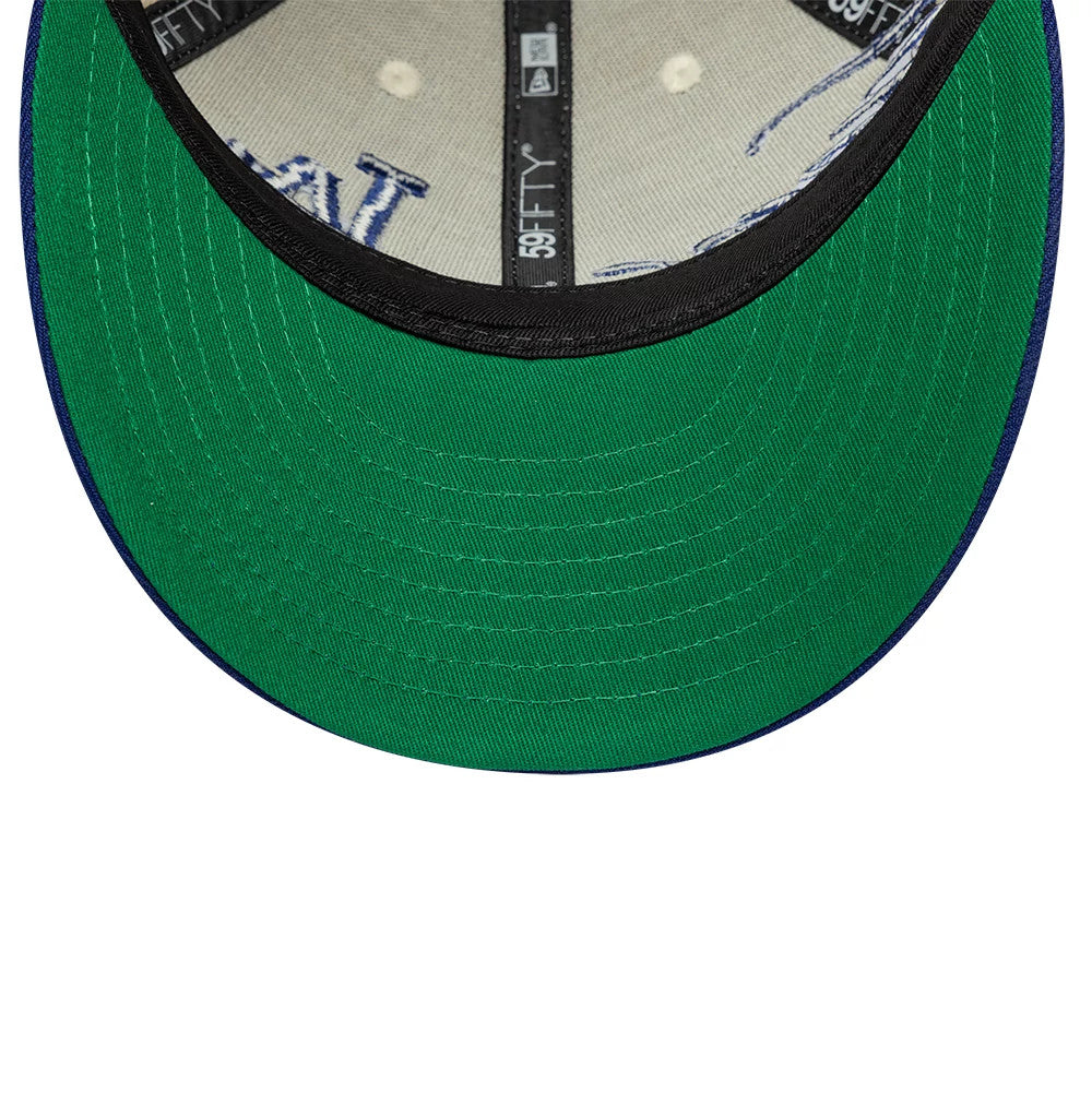 LA Dodgers MLB Side Script Cream Low Profile New Era 59FIFTY Fitted Cap, inside view showing a green undervisor contrasted with black interior taping, printed 59FIFTY labels and cream fabric with embroidered blue LA script details.