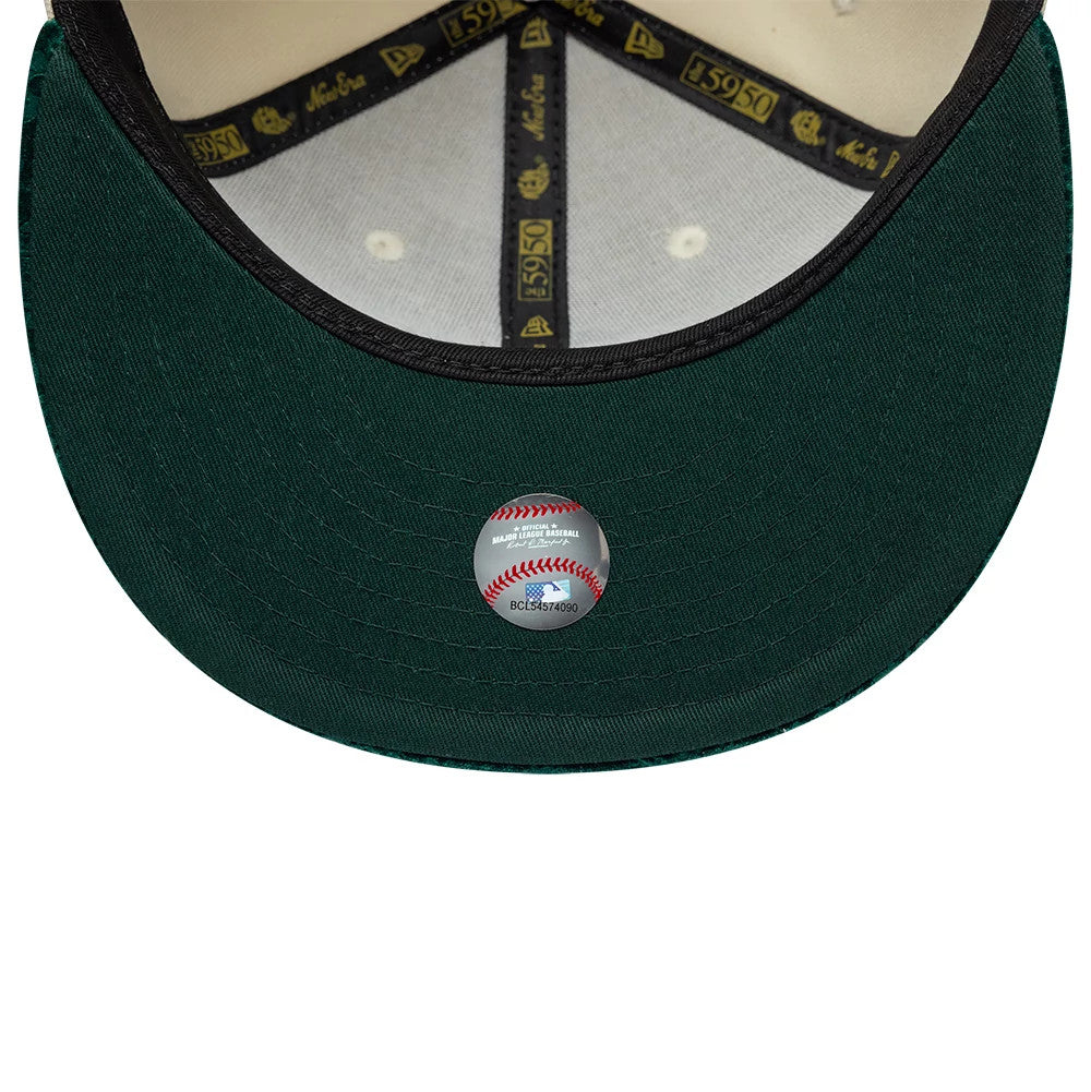Athletics MLB Paisley Visor Cream New Era 59FIFTY Fitted Cap, inside view showing a dark green undervisor with an MLB logo sticker, black internal taping featuring New Era and 59FIFTY logos, and a cream sweatband for added comfort.