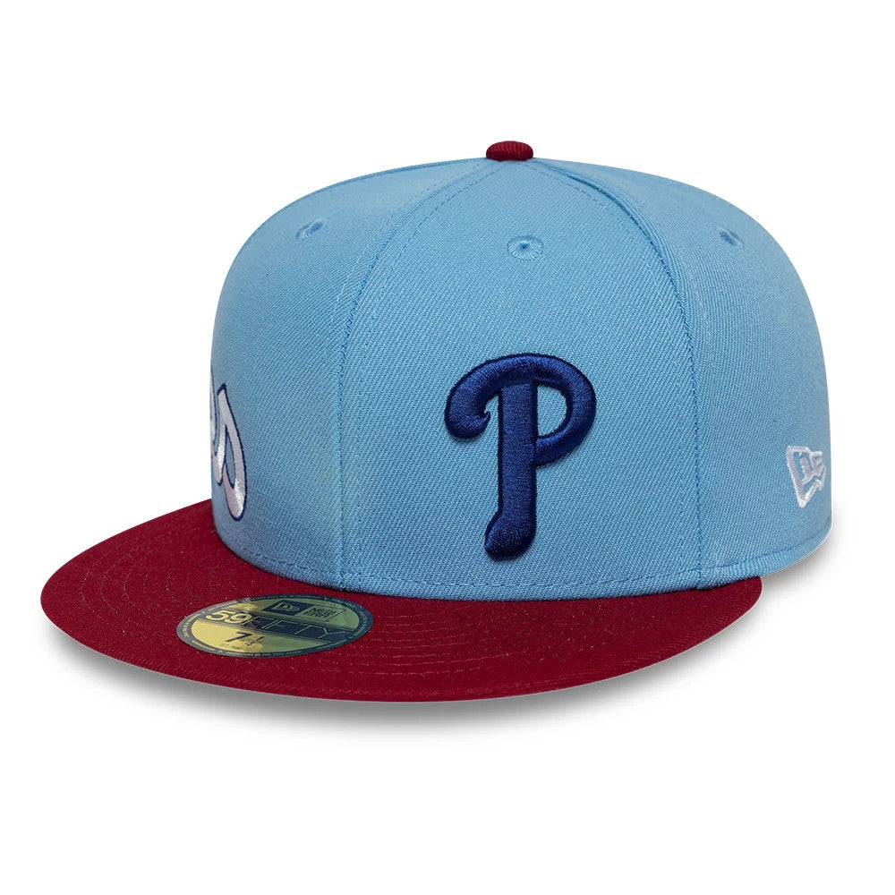 Philadelphia Phillies MLB Multi Logo Satin Lined Pastel Blue New Era 59FIFTY Fitted Cap, three-quarter view with a dark blue embroidered P on the front panel, contrasting red visor with a gold 59FIFTY size sticker.