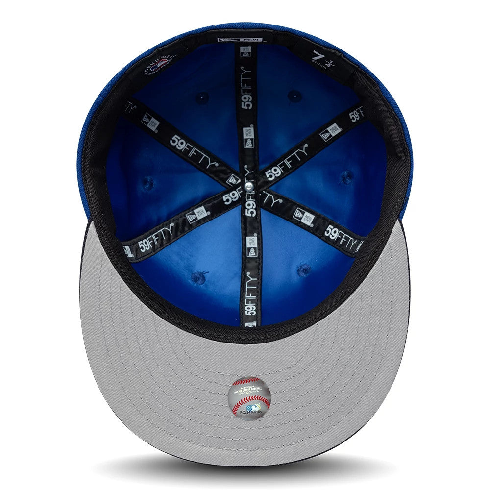 LA Dodgers MLB Multi Logo Satin Lined Blue New Era 59FIFTY Fitted Cap, inside view featuring a blue satin lining, black 59FIFTY branded taping across the interior, and a grey undervisor with a decorative baseball emblem sticker.