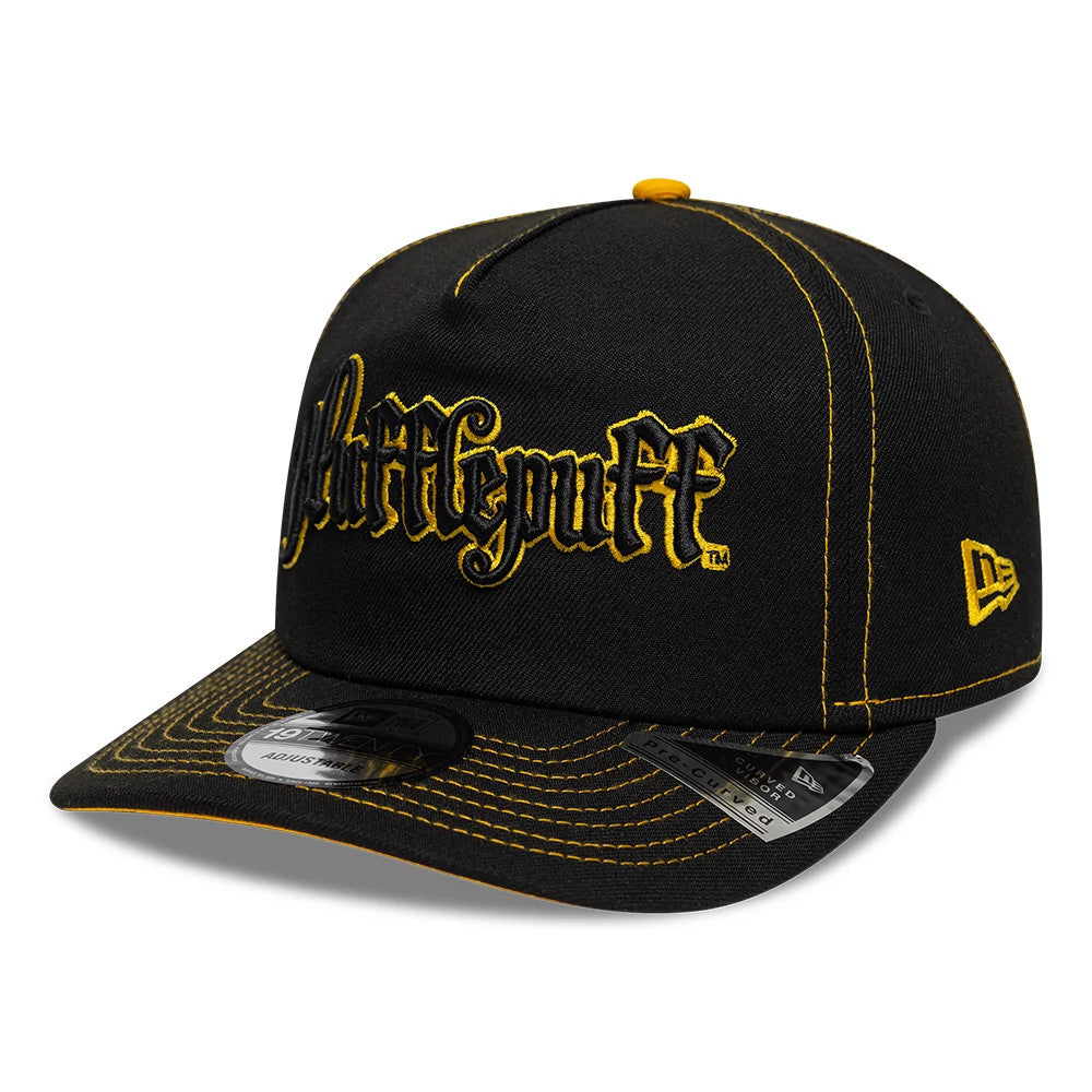 Harry Potter Hufflepuff Black New Era 19TWENTY Adjustable Cap, front view showing raised yellow Hufflepuff script embroidery on the black crown, black visor with detailed yellow stitching, and New Era flag logo on the left side.