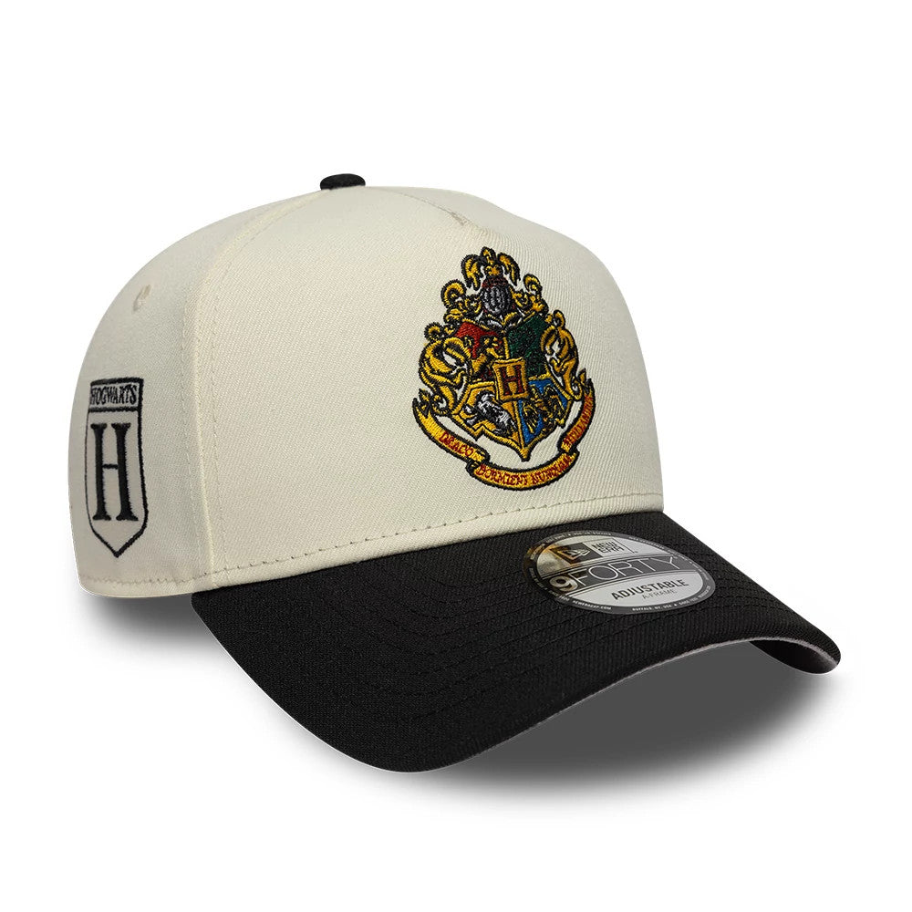 Harry Potter Hogwarts White & Black New Era 9FORTY A-Frame Adjustable Cap, front view showing the embroidered multi-coloured Hogwarts crest on the white front panel, with a black curved visor and a 9FORTY size sticker on the top.