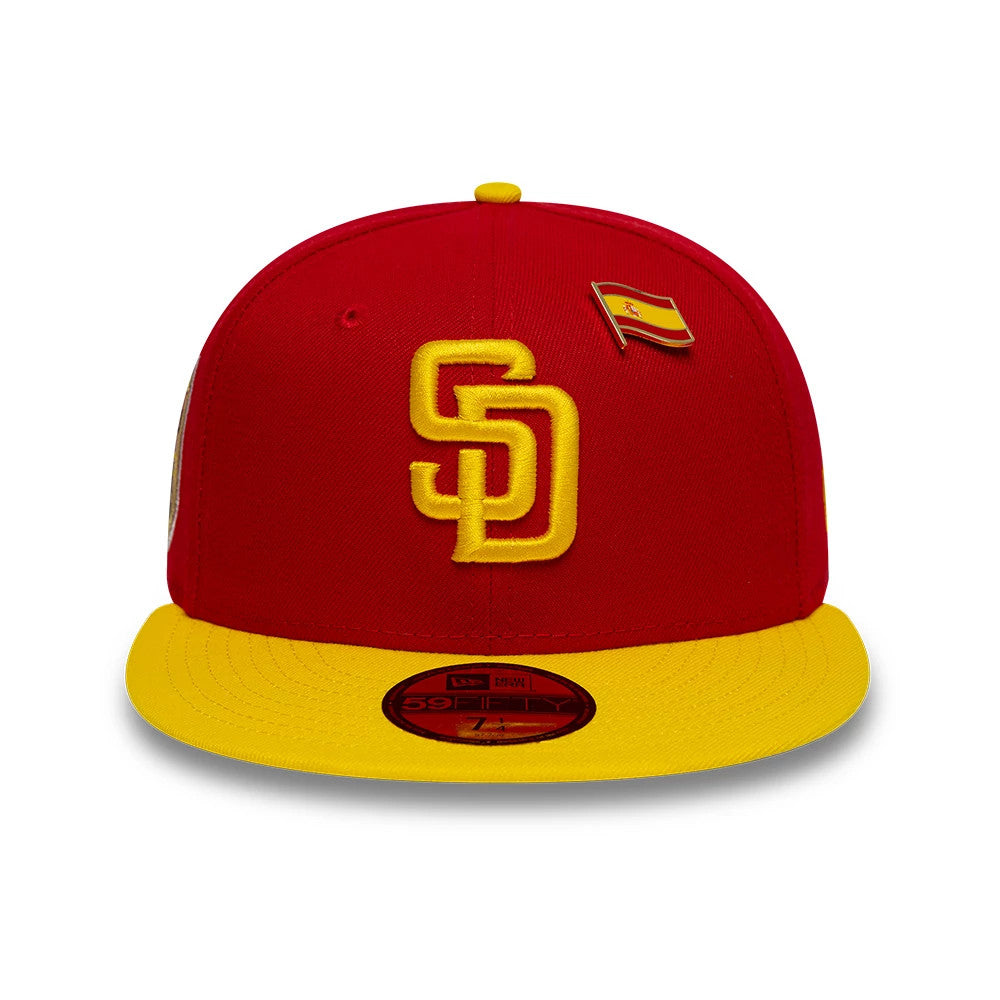 San Diego Padres MLB Sister Cities Red & Yellow New Era 59FIFTY Fitted Cap, front view showing a yellow raised embroidered SD logo on the red crown, a matching yellow visor, and a red 59FIFTY size sticker on the visor.