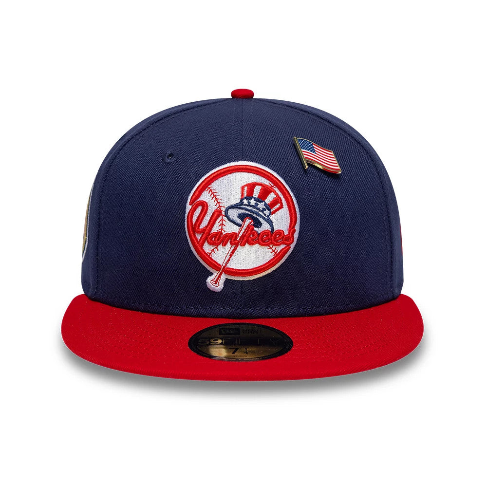 New York Yankees MLB Sister Cities Blue & Red New Era 59FIFTY Fitted Cap, front view showing the white and red embroidered Yankees logo centred on a blue crown, with an American flag pin, red visor and gold 59FIFTY size sticker.
