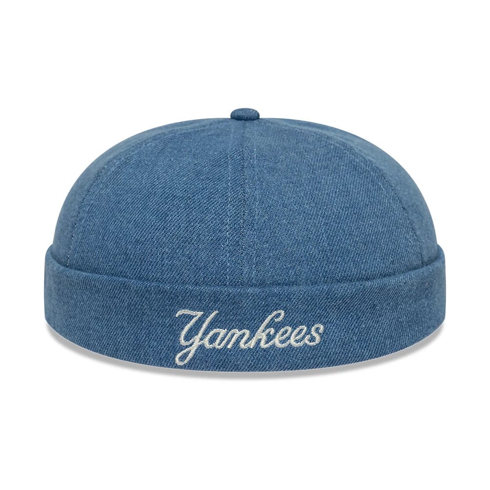 New Era New York Yankees MLB Denim Skully Pastel Blue Docker Adjustable Cap, rear view showing white Yankees script embroidery centred on the rolled denim cuff, with a flat crown design and a top button in matching pastel blue fabric.