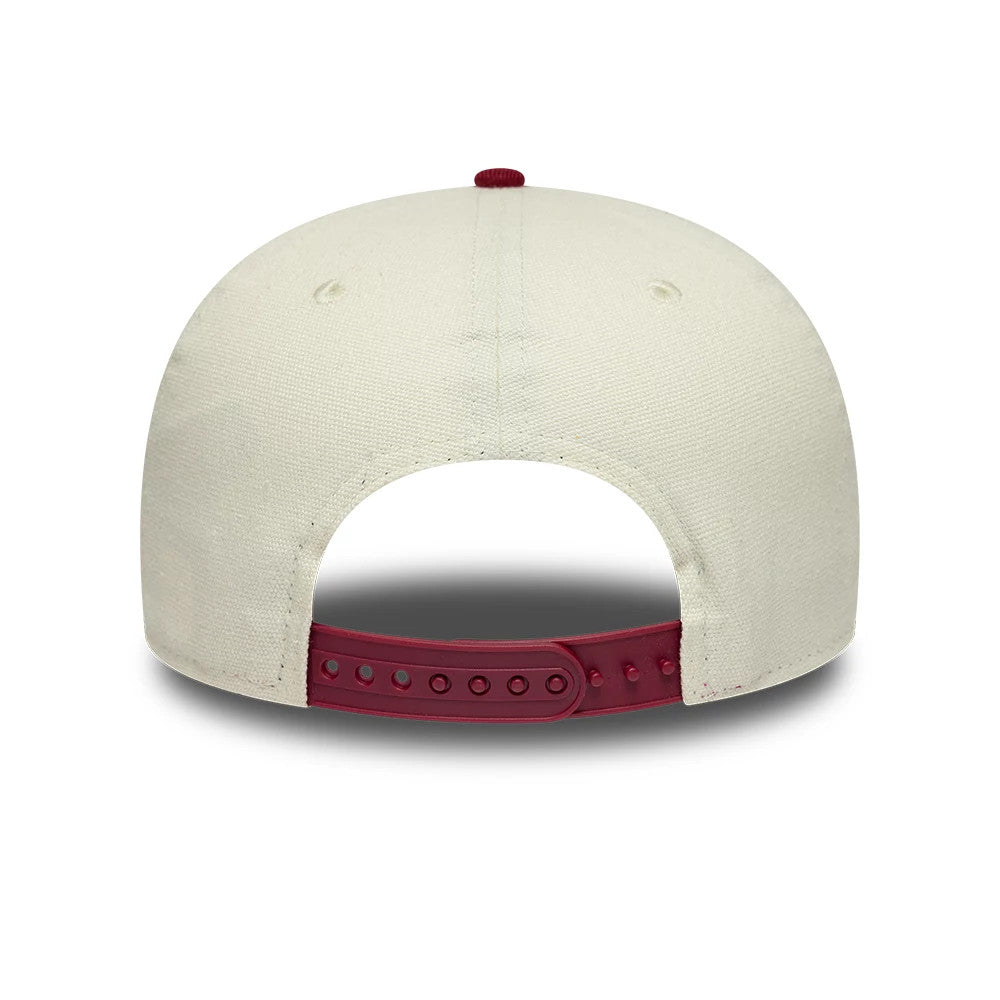 New Era Cream 19TWENTY Adjustable Cap, rear view showing a burgundy adjustable strap with multiple size holes, a matching burgundy top button, and a cream crown with eyelets on the structured panels.