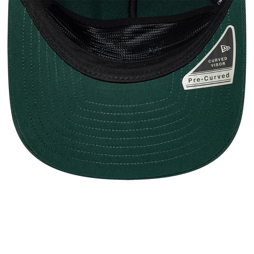 New Era Dark Green 19TWENTY Adjustable Cap, inside view showing the black sweatband, a green undervisor with prominent stitching, and a curved visor sticker on the right-hand side highlighting the pre-curved design.