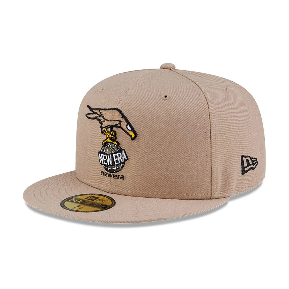Roji Soccer Beige New Era 59FIFTY Fitted Cap, front view showing an intricately embroidered design of a hand holding a New Era globe logo on the beige front panel, with a matching flat visor and a 59FIFTY size sticker.