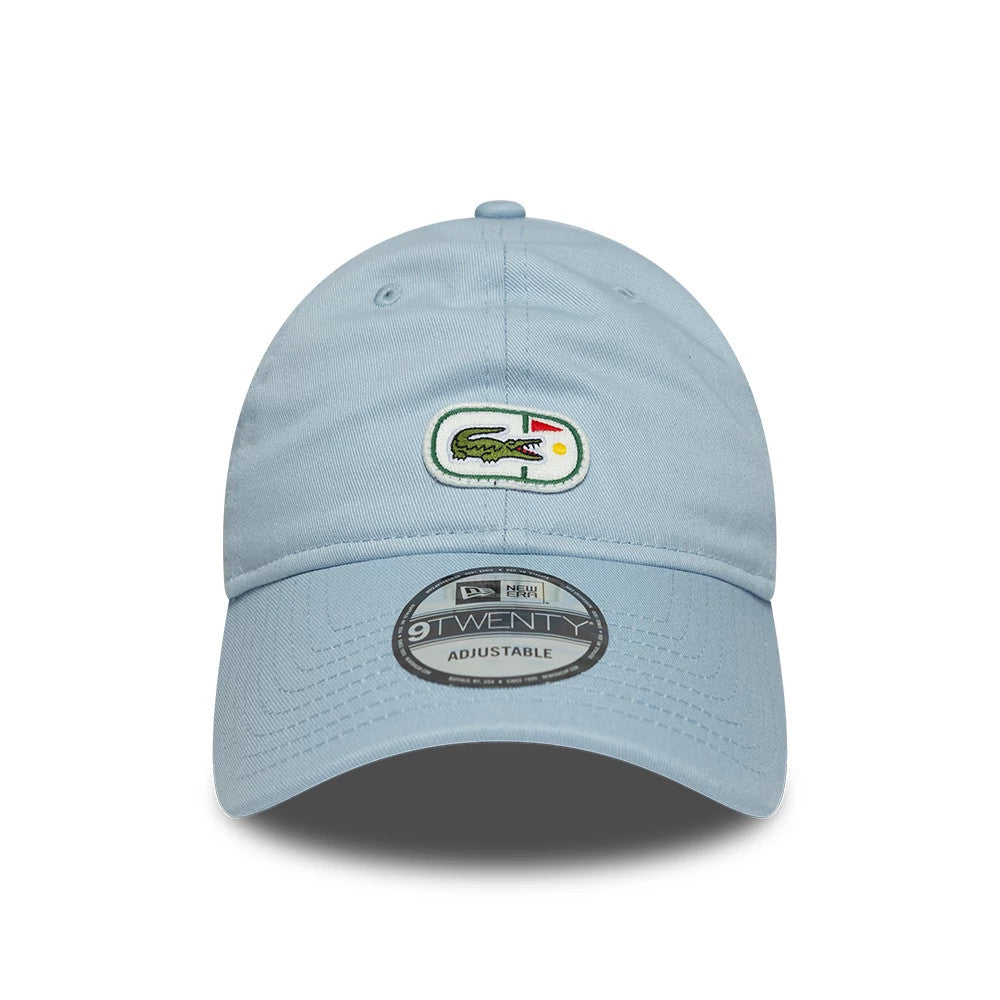 Lacoste X New Era Pastel Blue New Era 9TWENTY Adjustable Cap, front view showing the embroidered Lacoste crocodile logo on the front panel, with eyelets for ventilation and a 9TWENTY size sticker on the curved visor.