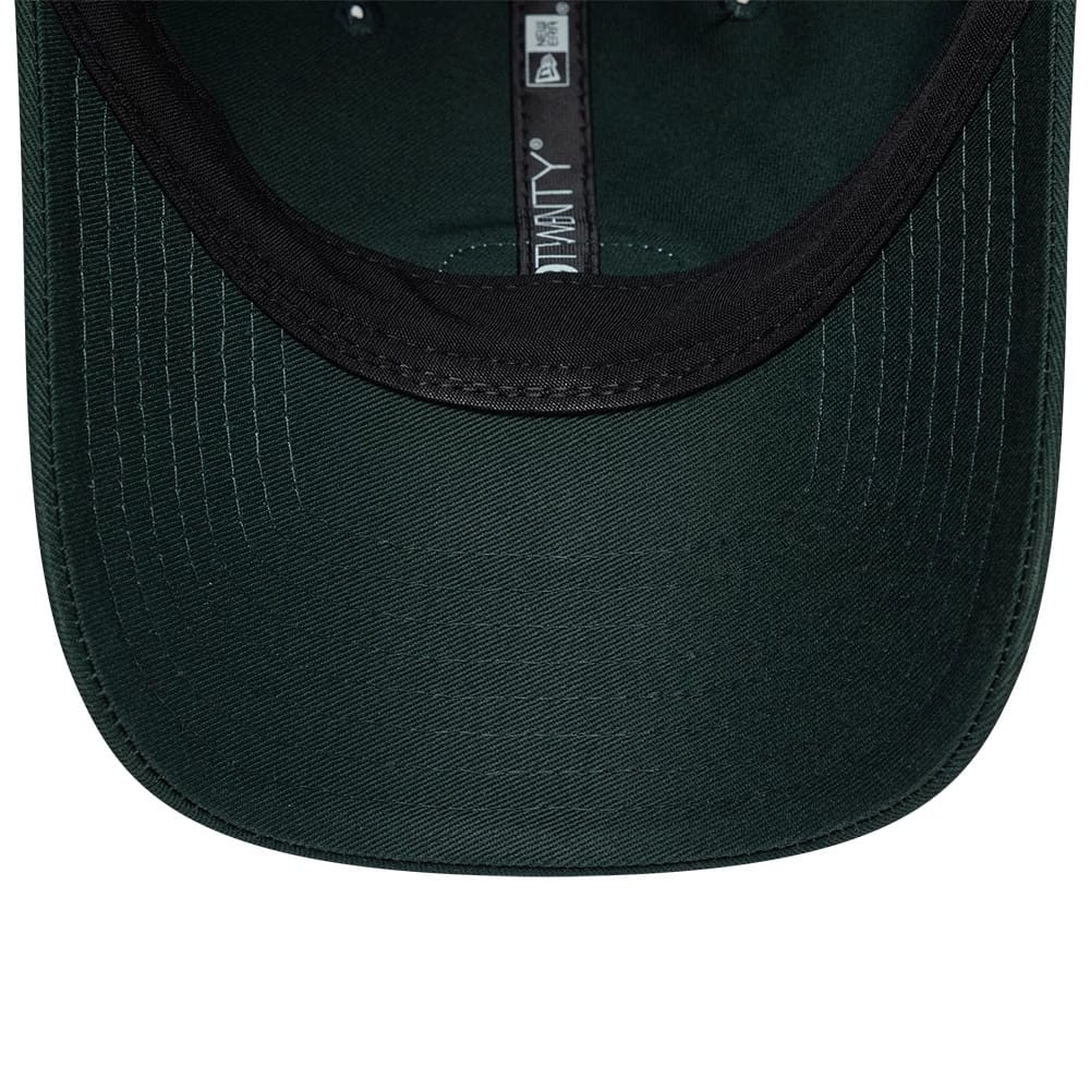 Lacoste X New Era Dark Green 9TWENTY Adjustable Cap, inside view showing the black sweatband lining the interior, dark green undervisor with stitching, and New Era 9TWENTY label along the inner crown seam.