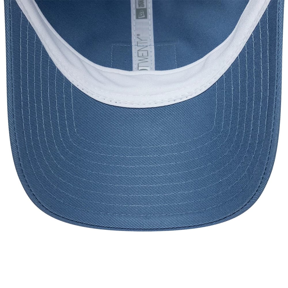 Lacoste X New Era Blue 9TWENTY Adjustable Cap, inside view showing the white sweatband, blue undervisor, and a New Era logo on the grey taping running along the centre, highlighting the detailed stitching pattern on the visor.