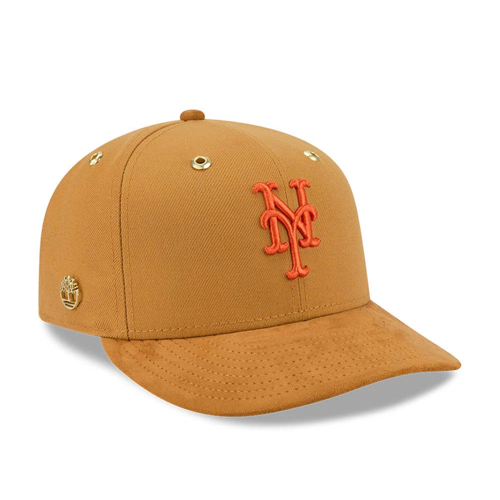 New York Mets Timberland X MLB Panama Tan New Era 59FIFTY Fitted Cap, three-quarter view showing an orange embroidered Mets logo on the front panel, with gold eyelets, a tan visor, and a gold Timberland logo on the left side above the visor.