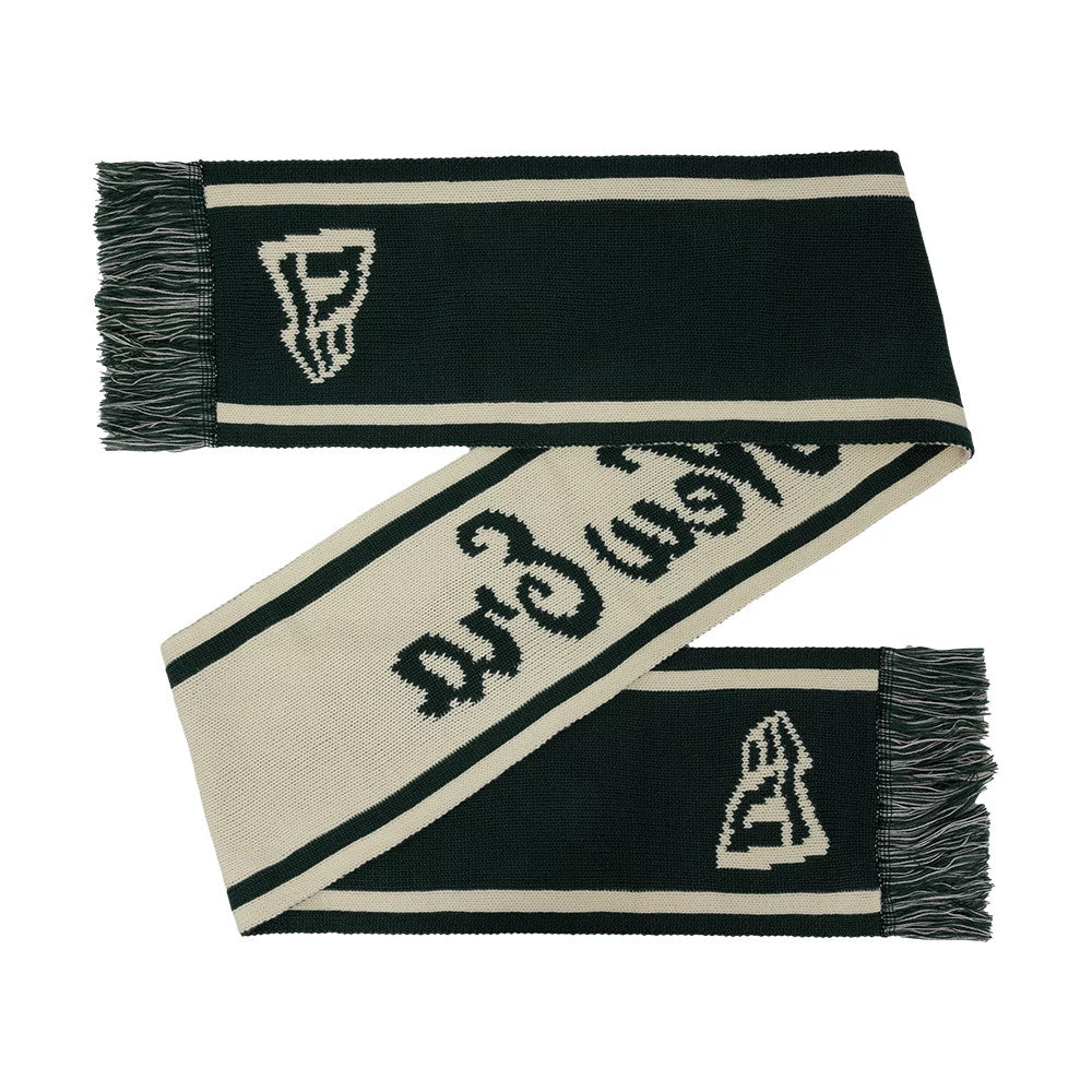 New Era Chunky Knit Dark Green Scarf, angled view displaying a dark green body with beige striping, intricate knitted logo patterns at each end, and tasselled fringes on both edges enhancing the textured look of the scarf.
