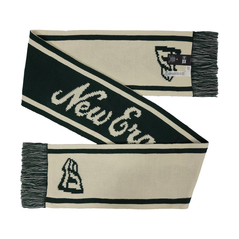 New Era Chunky Knit Dark Green Scarf, front view displaying the elegant knit pattern with New Era in large white lettering across the middle, a New Era logo in white on one end, and dark green fringes lining both ends of the scarf.